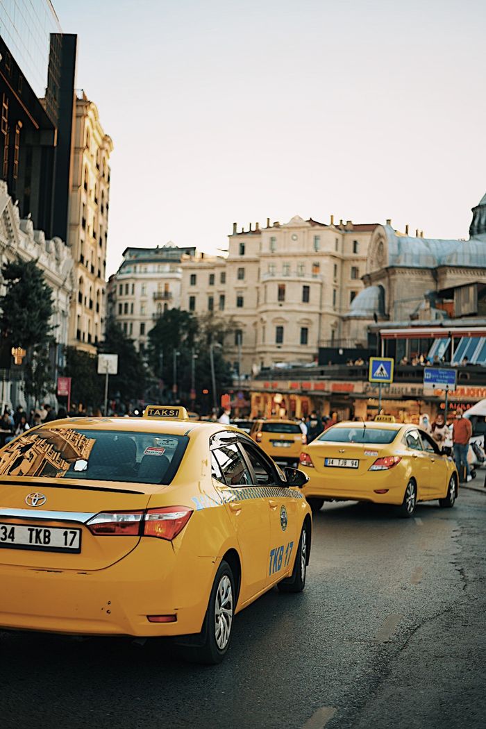 services-01 Istanbul street featuring yellow taxis and classic architecture, capturing urban life.